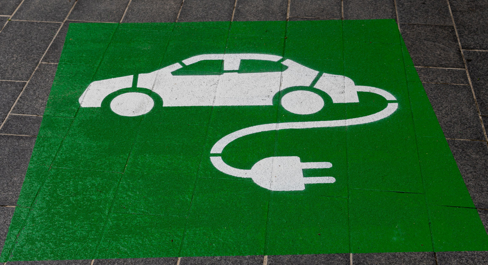 Electric vehicle charging at dusk